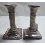 A pair of early 20thC silver dwarf candlesticks,