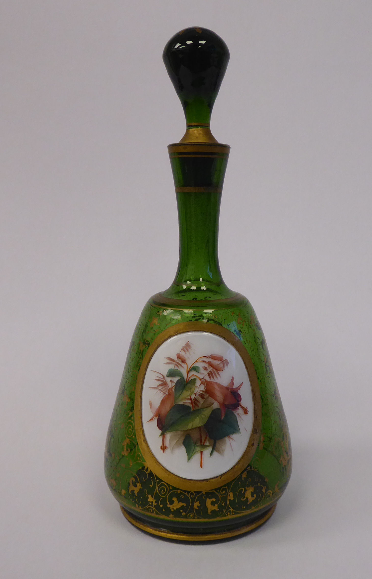 A late 19thC Bohemian decoratively gilded, green glass, mallet shaped dressing table decanter,