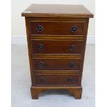 A 20thC crossbanded yewwood four drawer chest,