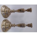 A pair of Continental silver coloured metal candlesticks, each having a vase shaped socket,