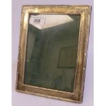 A glazed silver photograph frame with ribbon tied and reeded ornament,