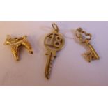 Three 9ct gold charms, viz.