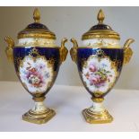 A pair of late 19th/early 20thC Coalport china ovoid shaped pedestal vases with rams' head handles