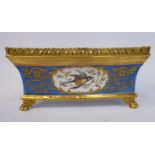 A late 19thC Continental porcelain planter of rectangular box design, having a flared,