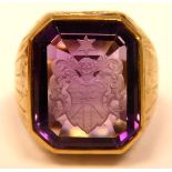 A gold coloured metal Bishop's ring, set with an amethyst,