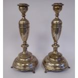 A pair of Continental silver coloured metal candlesticks, each having a vase shaped socket,