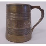 An Irish silver Christening tankard of tapered form with finely engraved panelled bands and a