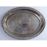 A George III silver kettle stand of oval form with decoratively cast and engraved stiff leaf,
