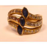 An 18ct gold three stone blue stone and diamond set ring