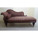An early Victorian mahogany chaise longue with an upholstered, scrolled back and arms,