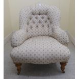 A late Victorian nursing chair, the later patterned fabric upholstered back,