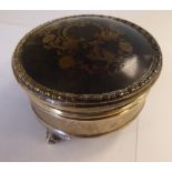 A silver circular ring box with a piquetworked tortoiseshell panel on the hinged lid,