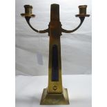 An Arts & Crafts period brass twin branch candelabra,