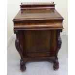 A mid Victorian burr walnut finished Davenport, the hinged lid with a hide scriber,