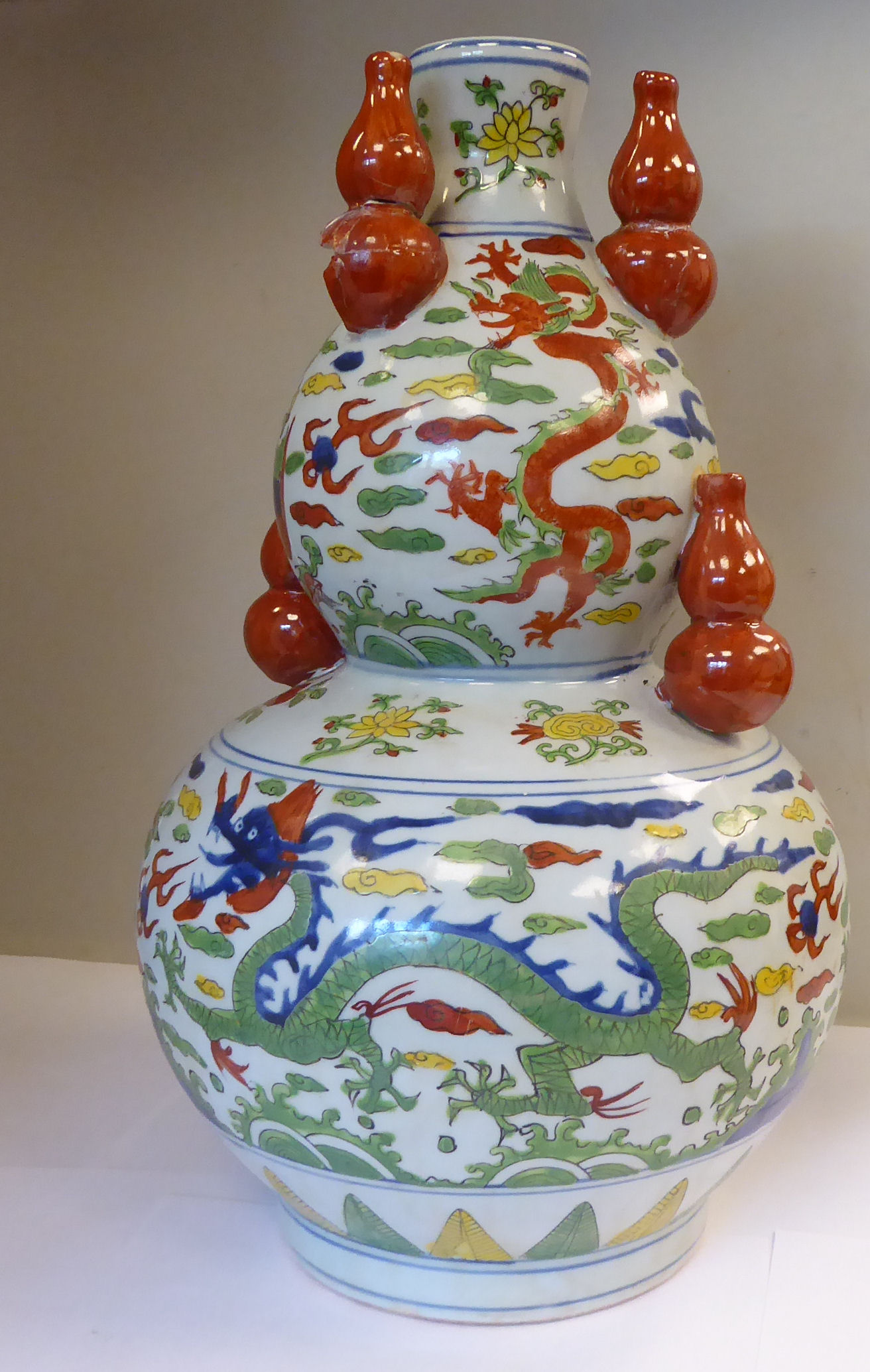 An early 20thC Japanese porcelain double gourd shaped vase, surmounted by five smaller vases,