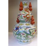 An early 20thC Japanese porcelain double gourd shaped vase, surmounted by five smaller vases,