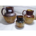 Three early 20thC Royal Doulton stoneware harvest jugs 5.5'' - 8.