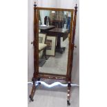 A Regency mahogany framed cheval mirror, the rectangular plate pivoting on turned horns,