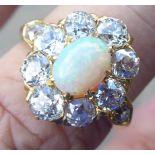 A gold coloured metal ring, set with an opal,