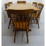 A Stewart Linford light oak dining table, the two part top with round corners,
