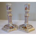 A pair of late 19thC Continental porcelain candlesticks of hexagonal form,