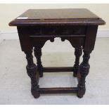 An early 20thC reproduction of an 18thC carved oak joint stool,