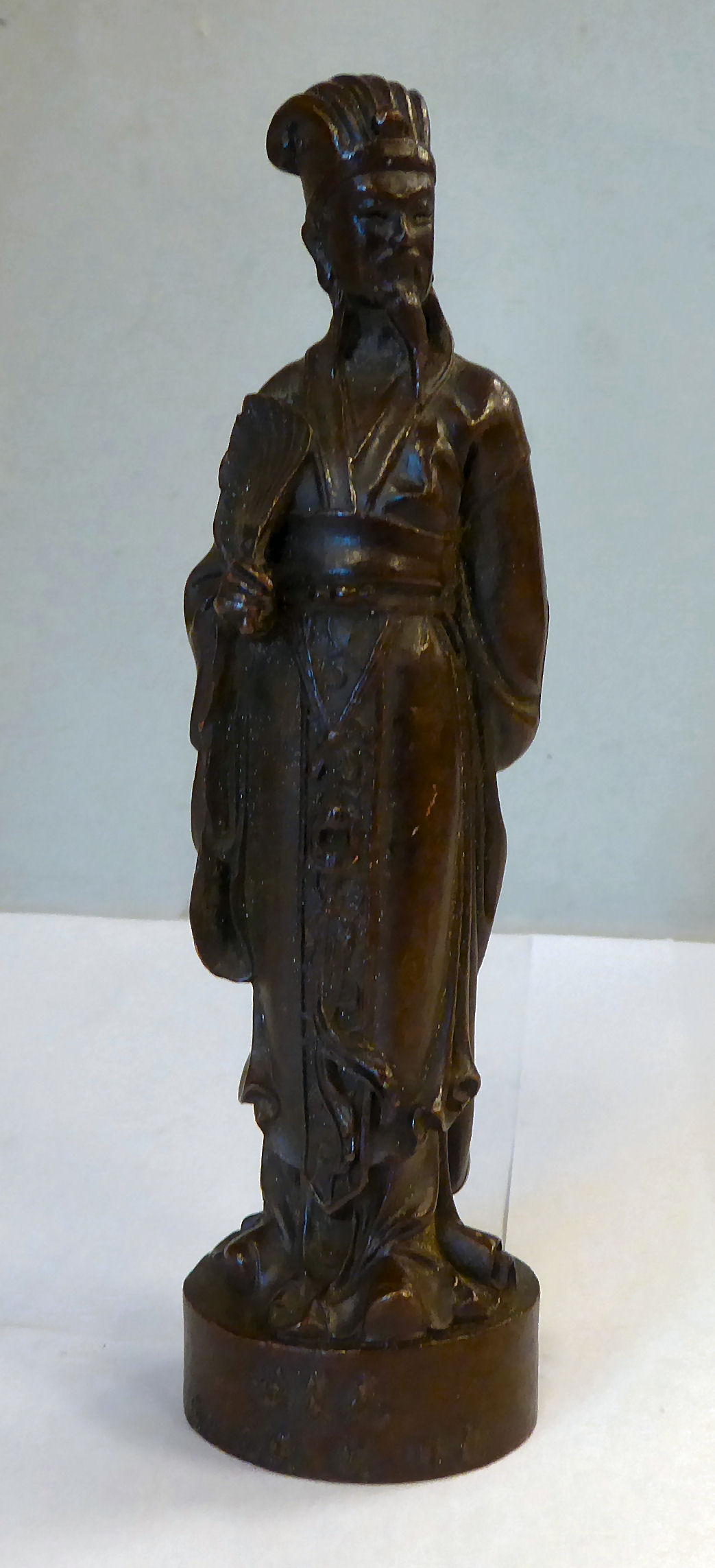 A late 19thC Japanese cast and patinated bronze standing figure,