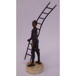 A late 19thC cast and patinated, parcel gilt bronze figure, a maintenance man,