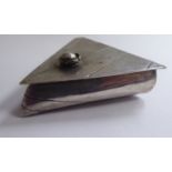 A white metal trinket box of triangular form, possibly Chinese, the hinged lid with an applied,