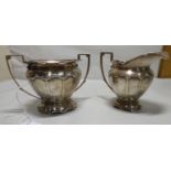 An early 20thC silver sugar basin and milk jug London 1914