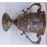 A George III silver cup, having a flared rim and opposing hollow, acanthus topped,