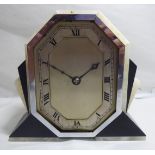 A 1930s Art Deco black slate and onyx cased mantel timepiece; faced by a silvered Roman dial,