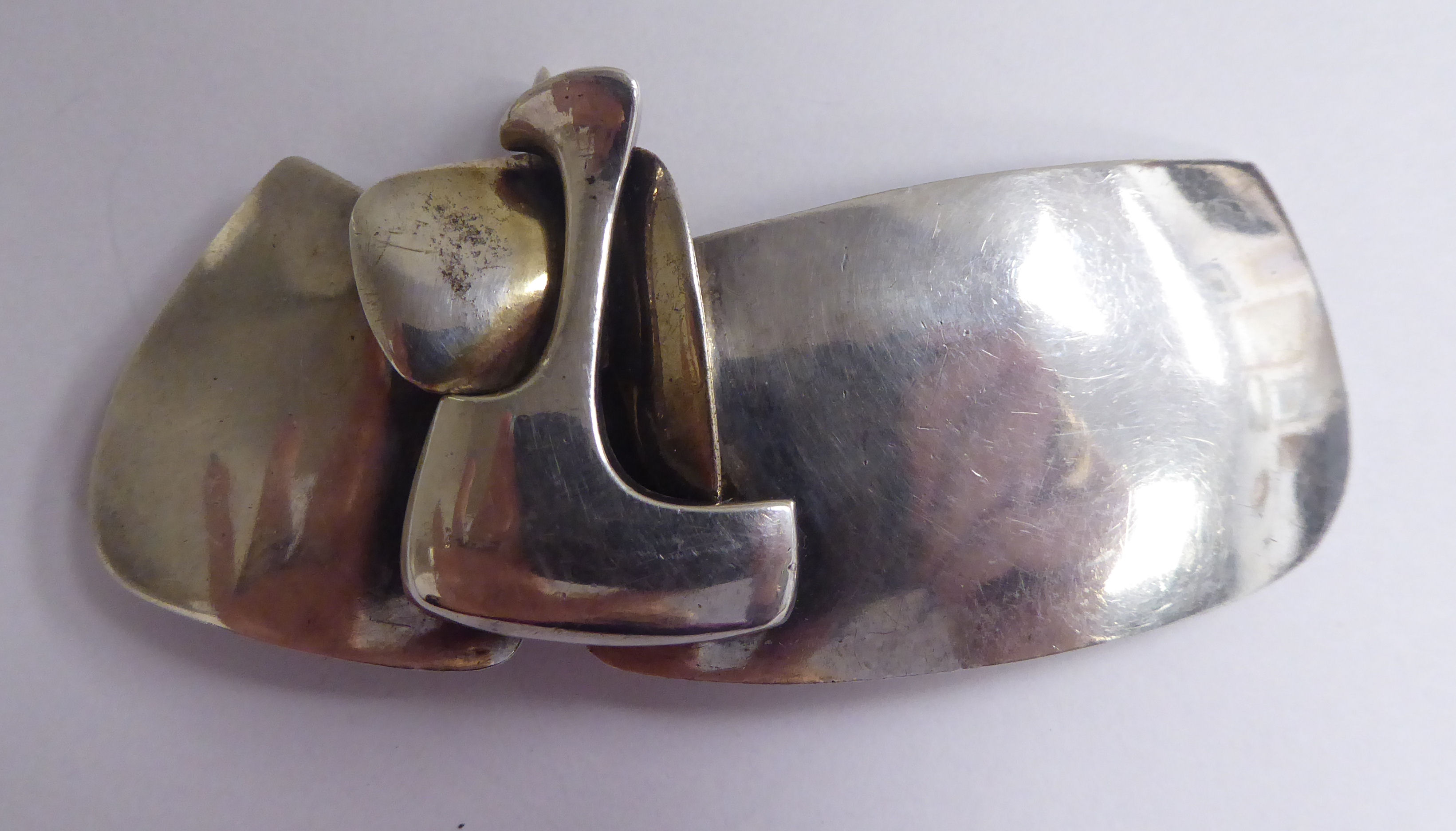 A Gilles Jonemann silver coloured metal brooch stamped 27