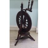 An early 19thC spinning wheel with turned pillar uprights and a spoked wheel,
