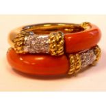 A gold coloured metal pink coral and diamond set double ring