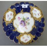 A 20thC Meissen porcelain footed dish, decorated with moulded and painted floral vignettes,