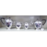 An Edwardian four piece silver tea set of ovoid form with shell and bellflower cast borders,