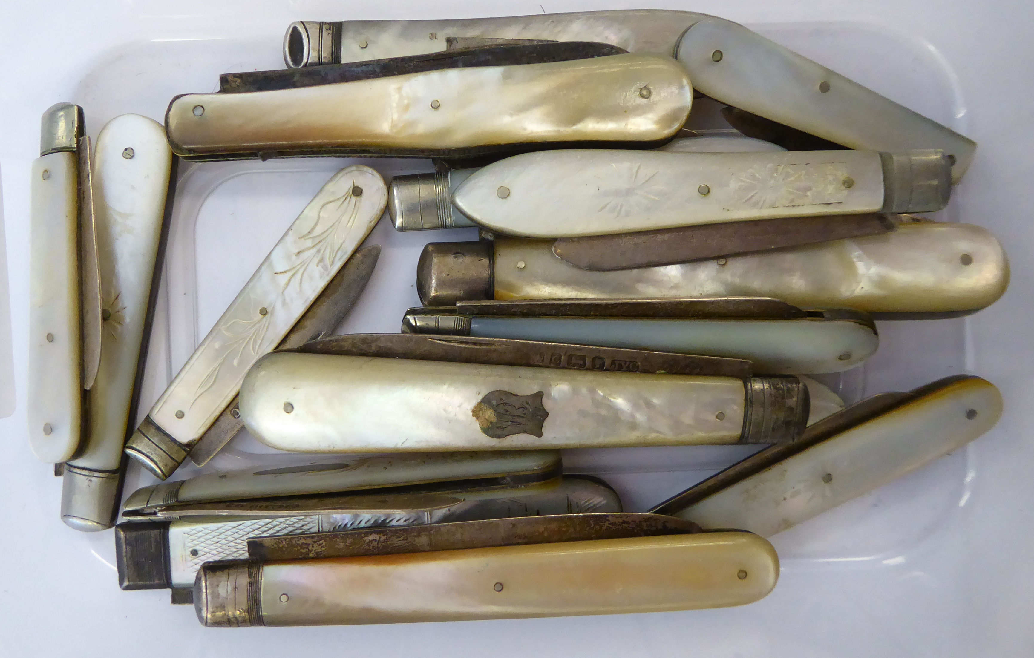 Seventeen similar 19th & 20thC folding fruit knives with mother-of-pearl handles and silver blades