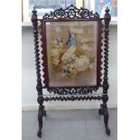 A late Victorian mahogany framed firescreen, the glazed tapestry panel,