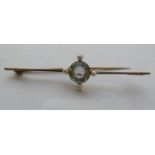 A gold coloured metal bar brooch,