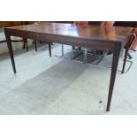 A modern Scandinavian rosewood finished dining table, raised on square,