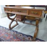 A 20thC stained oak finished, three drawer hallrobe,