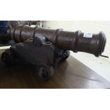 A cast iron model canon on a wooden frame 6''h BSR
