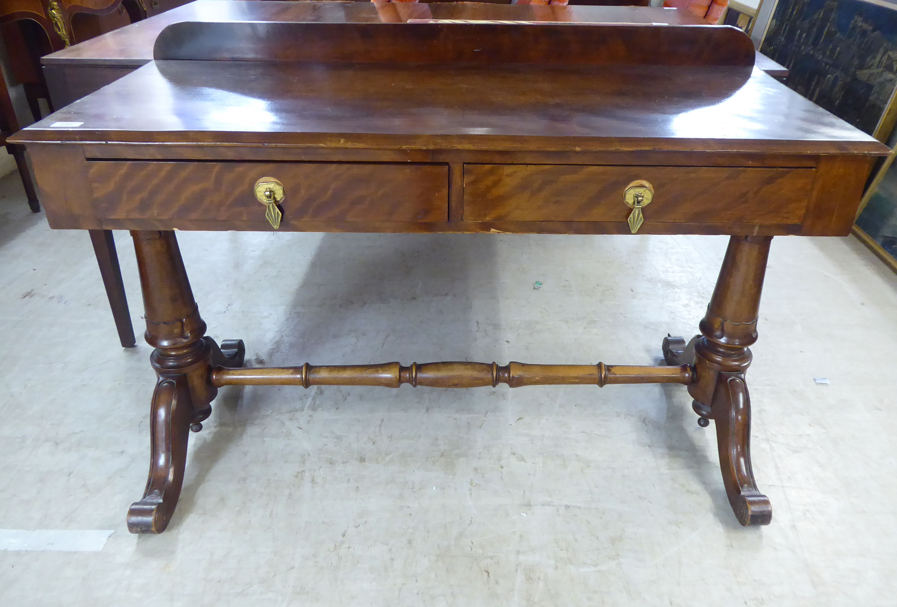 A late 19thC mahogany hall table, the top with a low upstand and chamfered edge, raised on carved,