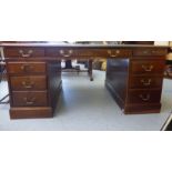 An early/mid 20thC mahogany nine drawer twin pedestal desk,