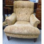 A modern reproduction of an early 20thC enclosed armchair with a high, level back,