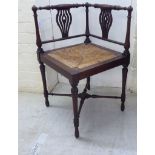 An Edwardian mahogany framed square corner chair, the level, spindled back with pierced splats,