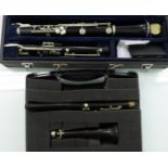 A small oboe, in a fitted plastic carrying case; and another, standard size,