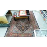 A Persian design rug, profusely decorated with stylised designs,