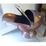 An early 20thC copper coal scuttle of open face helmet design 16''h BS